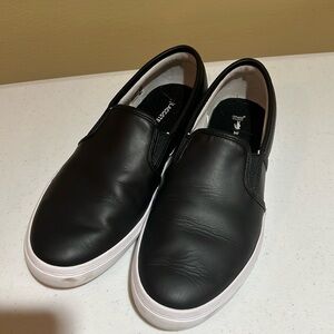 Black Lacoste shoes.